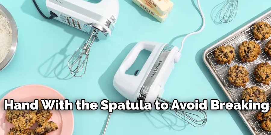 Hand With the Spatula to Avoid Breaking